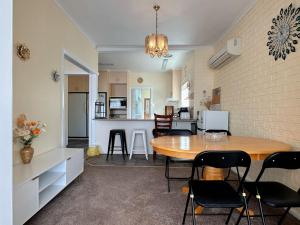 a dining room and kitchen with a table and chairs at Coleman Comfort Hub - close to City&Air port in Moonah +16 photos