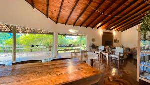 a living room with a large wooden table and chairs at Casa Mirante da Serra em Tiradentes - MG in Tiradentes