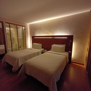 Sacha's Hotel Uno客房内的一张或多张床位