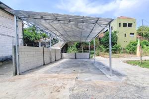 a large metal canopy in front of a building at RedDoorz Syariah Near Alun-Alun Kudus in Kudus