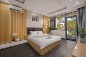 a bedroom with a large bed and a large window at Hùng Villa 5br Full Ac Quite -Rooftop Pool- Bida- New in Da Nang +41 photos