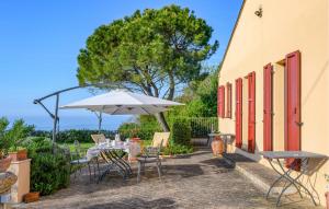 a patio with a table and an umbrella at Amazing Home In Montemarciano With Wifi in Alta Marina +27 photos