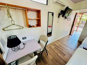 a small room with a white table and chairs at Legoon View in Tortuguero