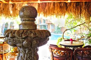 a stone fountain in the middle of a patio at The Bungalows Hotel in Cabo San Lucas