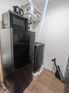 a refrigerator with a microwave on top of it at -Summer Escape- Just 15 min from Haneda Airport, Max 3 in Tokyo