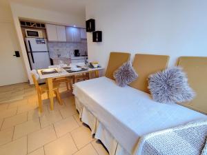 a kitchen with two chairs and a table and a kitchen with a kitchen at Céntrico con vistas Ushuaiayvos in Ushuaia