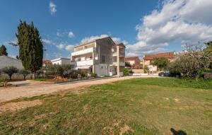 a house with a large yard in front of it at Gorgeous Apartment In Novalja With Wifi in Novalja