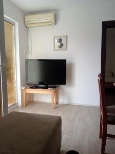 a living room with a flat screen tv on a table at Vila Milano in Rakari