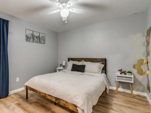a bedroom with a bed with a ceiling fan at OKC Casita - Newly Remodeled, Modern 2 BR home - Family and pet friendly Plus Hot tub in Oklahoma City