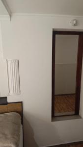 a mirror on a wall next to a bed at Ginjals 67 in Almargem do Bispo +26 photos