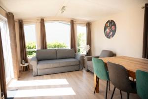 a living room with a table and a couch at Leeuwendamme in Serooskerke