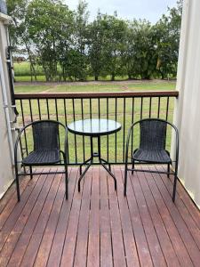 two chairs and a table on a deck at Ingham Tourist Park in Ingham +7 photos