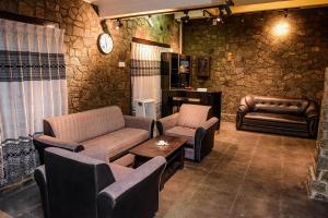 a living room with a couch and chairs and a table at Kandy Paradise Hotel & Spa in Gelioya