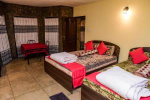a living room with two beds and a couch at Kandy Paradise Hotel & Spa in Gelioya