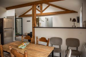 a kitchen with a wooden table and chairs at Cottage tout confort neuf au calme 6p WiFi in Chaumes en Retz