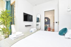 una camera con un grande letto e uno specchio di Charming and cosy flat next to the Eiffel Tower a Parigi