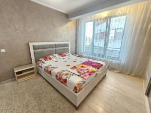 Postel nebo postele na pokoji v ubytování Alegna Holiday house Mamaia Nord