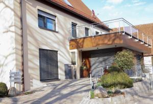 a house with a staircase on the side of it at Fewo Sonnblick in Windsbach