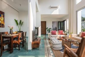 a living room with a table and a couch at La Olalian 2 & 3 BHK Designer Villas Near Anjuna Beach with Private Pool & Sun Deck & Garden in Anjuna