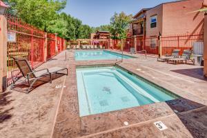 a swimming pool in a yard with two chairs at The Gonzo Inn in Moab