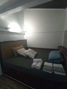 a bed with towels and pillows on top of it at Ginjals 67 in Almargem do Bispo