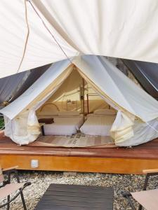 a large white tent with two beds in it at Happy Garden in Kampong Tenompok