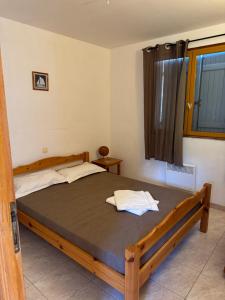 a bedroom with a wooden bed in a room at Altagna in Olmeto