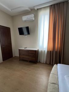 TV o dispositivi per l'intrattenimento presso Guest House Inn Side