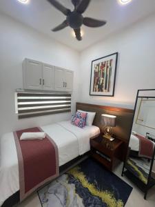 a bedroom with two beds and a ceiling fan at Myra Guesthouse Bohemian Style Mutiara Ville Duplex Apartment in Cyberjaya +19 photos