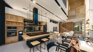 a living room with a kitchen with a table and chairs at Seis E Villa 4 Bedroom In Canggu in Badung