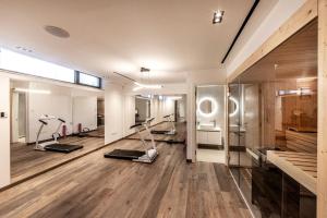 a gym with treadmills and exercise equipment in a room at Villa JoJo Seafront in Ayia Napa