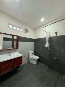 a bathroom with a sink and a toilet and a shower at CaBu House Homestay Long Hải in Long Hai