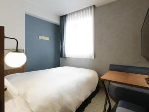 Кровать или кровати в номере Comfort Hotel Yokkaichi