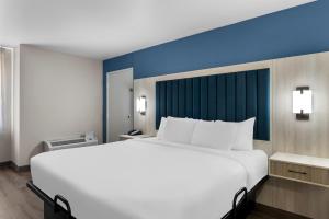 a large white bed in a hotel room at Park Inn by Radisson in San Antonio +39 photos