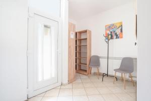 a room with two chairs and a door at Villa Otto in Dunajská Streda