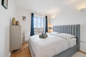 ein Schlafzimmer mit einem großen Bett mit einem großen Fenster in der Unterkunft Modern and central 1BR Flat with Skyline View in London