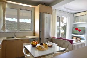 Una cocina con una mesa con un bol de fruta encima. en Mailia Lagoon, en Vivari