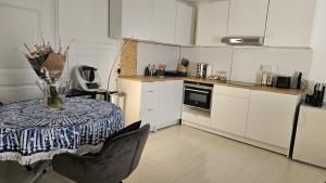 a kitchen with a table with a vase on it at Terrasses de Valère in Sion