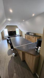 a large kitchen with a large wooden counter top at Appartement à Gravelines in Gravelines