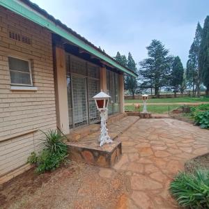 a porch of a house with a stone patio at Cottage at Yellowstone in Springs +6 photos