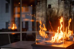 a fireplace filled with fire in a room at Parkhotel Rügen in Bergen auf Rügen