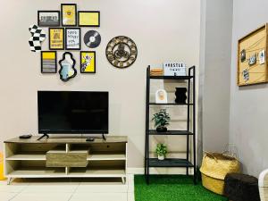 a living room with a tv on a wall at M Suite Homestay, Sutera Avenue Kota Kinabalu - Near Imago in Kota Kinabalu