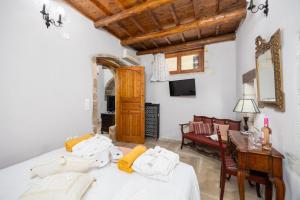 a bedroom with a bed and a desk and a couch at Villa Anta in Astérion +27 photos