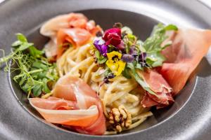 a plate of food with pasta and vegetables on it at Parkhotel Rügen in Bergen auf Rügen