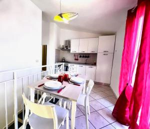a dining room with a white table and chairs at New Naxian Holidays in Giardini Naxos
