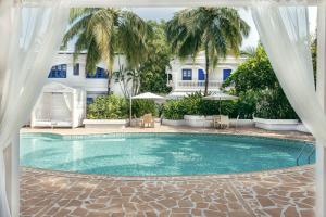 a swimming pool in front of a house at Soul Vacation Resort and Spa,Colva in Colva