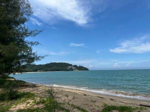 a view of a beach with trees and the ocean at Villa Beradu Cherating ,Three bedroom house in Cherating