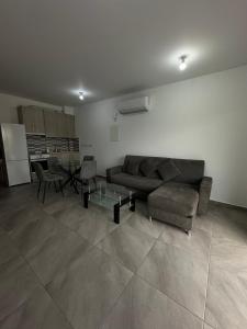 a living room with a couch and a table at Oroklini's Flat in Larnaka