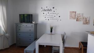 a dining room with a table and a tv at Ferienwohnung Weinberg mit tollem Moselblick in Oberfell