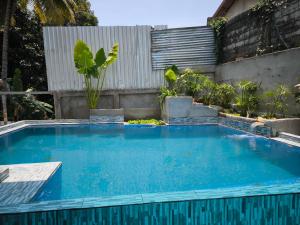 a swimming pool in a backyard with a fence at Vang Vieng Champa Resort in Vang Vieng